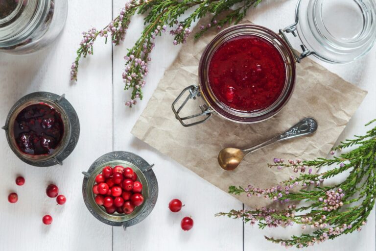 An overhead photo of Thanksgiving cannabis-infused cranberry sauce, styled on a rustic wooden table with fresh cranberries. A festive edible recipe made simple.